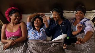 The Flossy Posse laughing in bed in Girls Trip